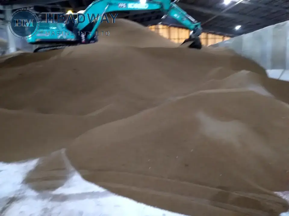 Bulk fertiliser stockpile in a receiving shed